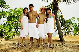 Asia Images Group - Young adults wearing towels, standing in a row, looking at camera