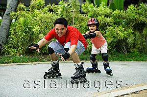 Asia Images Group - Father and daughter inline skating