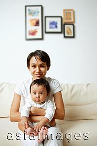 Asia Images Group - Mother with baby boy, sitting on sofa, portrait