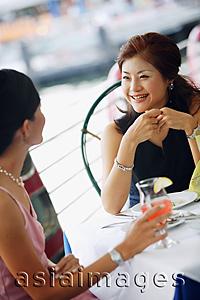 Asia Images Group - Two women having lunch, smiling