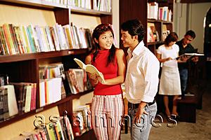 Asia Images Group - Couple at bookstore, looking at books