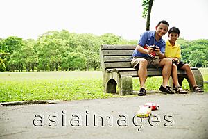 Asia Images Group - Father and son playing with remote control cars