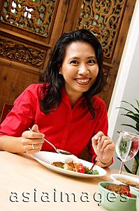Asia Images Group - Woman having a meal, smiling at camera