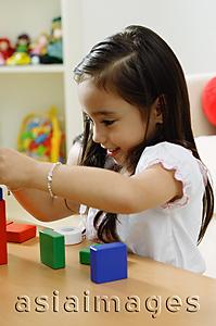 Asia Images Group - Girl playing with building blocks