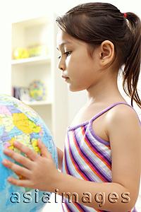Asia Images Group - Young girl holding globe