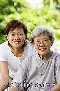 Asia Images Group - Two generations of women, smiling at camera