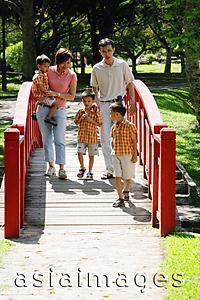 Asia Images Group - Family with three boys walking across bridge
