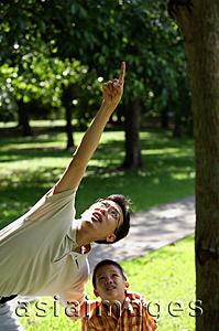 Asia Images Group - Father and son in park, father pointing up