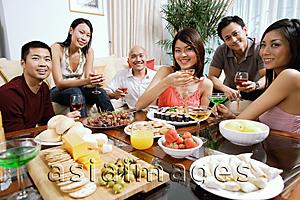 Asia Images Group - Adults having a party in living room, smiling at camera, food on coffee table