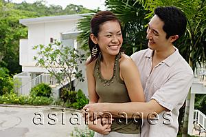 Asia Images Group - Man embracing woman, both smiling