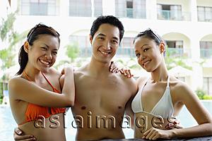 Asia Images Group - One man standing between two woman dressed in bikinis