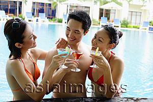 Asia Images Group - Young adults in swimming pool with cocktail drinks