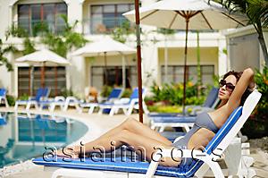 Asia Images Group - Woman in swimwear, sitting on deck chair