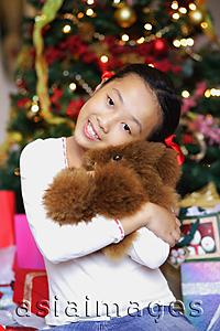 Asia Images Group - Girl holding teddy bear, looking at camera