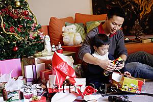 Asia Images Group - Father and son opening gifts on Christmas, portrait