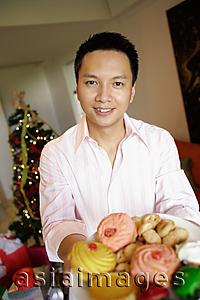 Asia Images Group - Man holding a plate of food