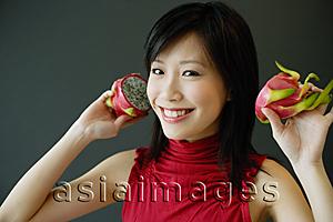 Asia Images Group - Woman holding dragon fruit