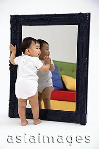 Asia Images Group - Baby boy standing against mirror