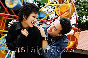 Asia Images Group - Couple at playground, looking at each other, laughing
