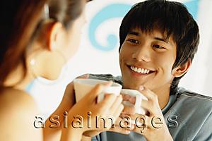 Asia Images Group - Couple having coffee, looking at each other