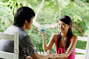 Asia Images Group - Couple sitting at cafe having drinks