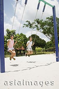 Asia Images Group - Young women on swings at playground