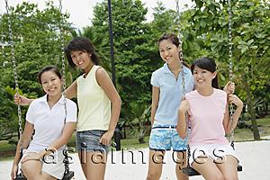 Asia Images Group - Young women in playground, smiling at camera