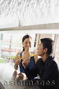 Asia Images Group - Couple having drinks at bar