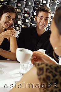 Asia Images Group - Young adults sitting in restaurant, having coffee
