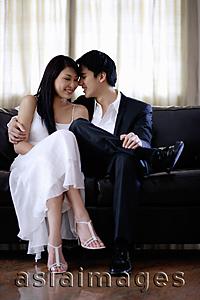 Asia Images Group - Well dressed couple sitting on sofa