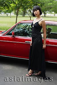 Asia Images Group - Woman in black dress looking at camera