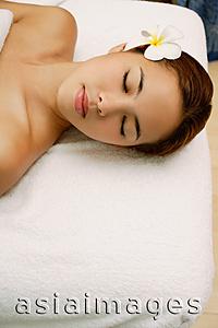 Asia Images Group - Young woman massage table, eyes closed, head shot
