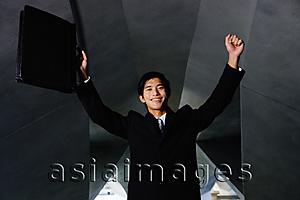 Asia Images Group - Businessman with arms raised, holding briefcase