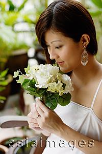 Asia Images Group - Young woman smelling bouquet of flowers