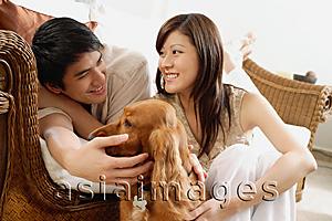 Asia Images Group - Couple at home with Cocker Spaniel dog