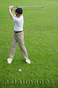 Asia Images Group - Man swinging golf club, selective focus