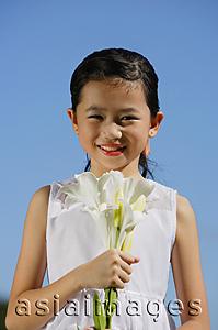 Asia Images Group - Girl holding bouquet of flowers, smiling at camera