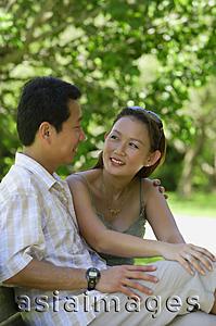 Asia Images Group - Mature couple sitting on bench, looking at each other