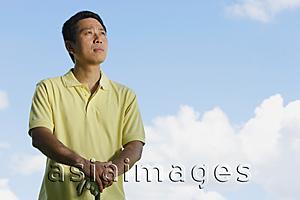 Asia Images Group - Man standing outdoors, looking away