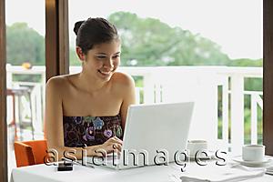 Asia Images Group - Woman in cafe using laptop