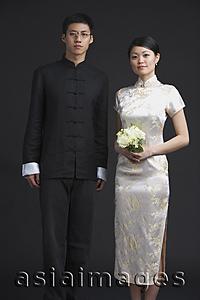 Asia Images Group - Man and woman dressed in traditional Chinese attire, woman holding bouquet