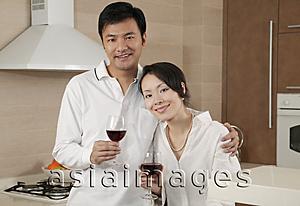 Asia Images Group - Couple in kitchen, looking at camera, portrait