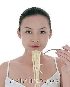 Asia Images Group - Young woman eating spaghetti