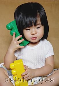 Asia Images Group - Young girl playing with toys