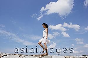 Asia Images Group - Woman walking on breakwater