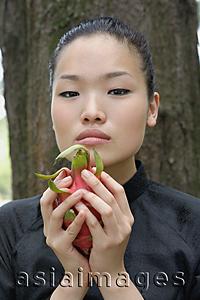 Asia Images Group - Young woman holding dragon fruit
