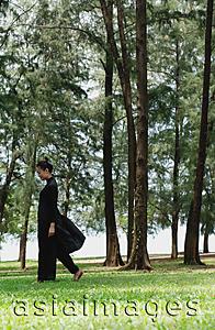 Asia Images Group - Young woman in traditional Chinese costume, walking amongst trees