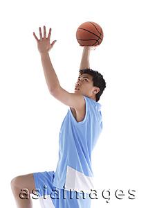 Asia Images Group - Young man with basketball, preparing to throw ball