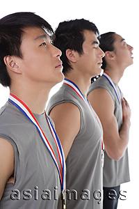 Asia Images Group - Three athletes in a row with medals around their necks
