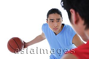 Asia Images Group - Two men playing basketball, over the shoulder view